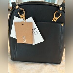 Miztique convertible bag. Converts from backpack to shoulder bag. Tags